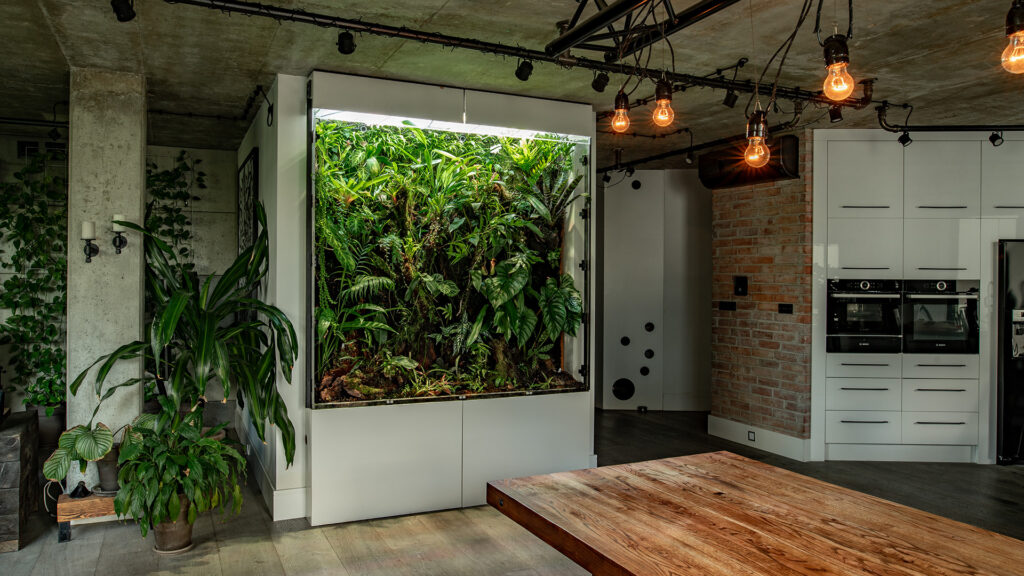 Wielkogabarytowe akrylowe terrarium roślinne jest unikatową dekoracją przestronnego apartamentu na warszawskiej Woli.
